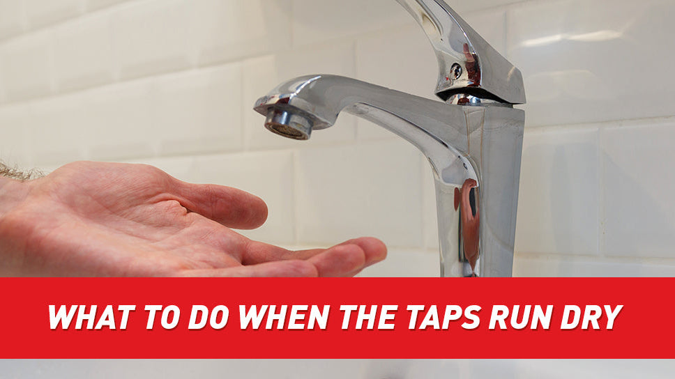 A person holding their hand under a faucet.