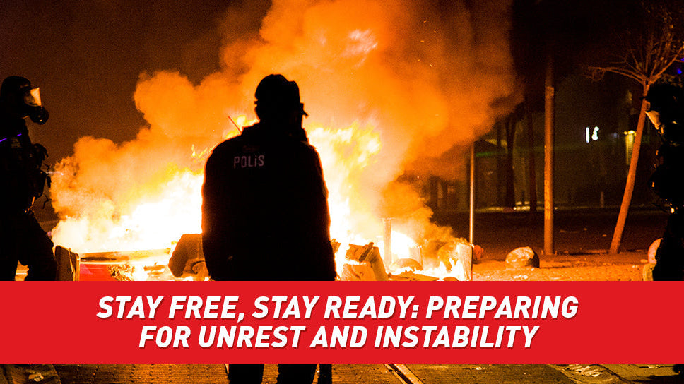 Silhouettes of police officers and citizens while a city burns into flames.
