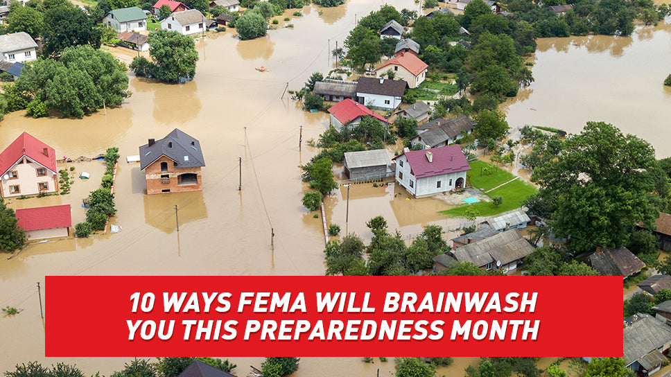 An aerial view of a suburban neighborhood, flooded with muddy water.