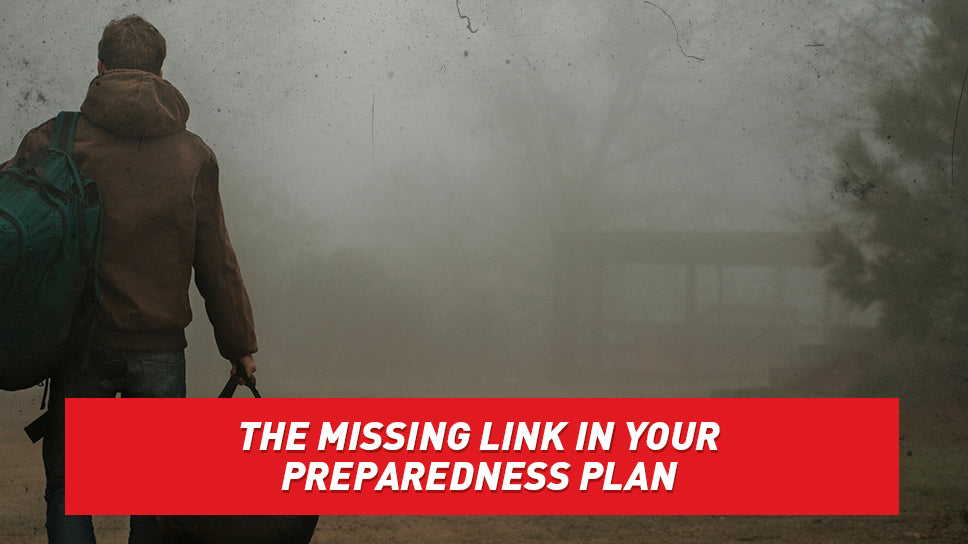 Man with backpack and duffel bag walking home in dark, ominous fog.