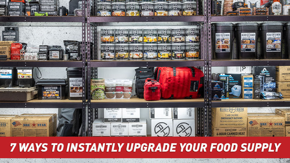 A wide, open room with shelves loaded with black buckets of emergency food.