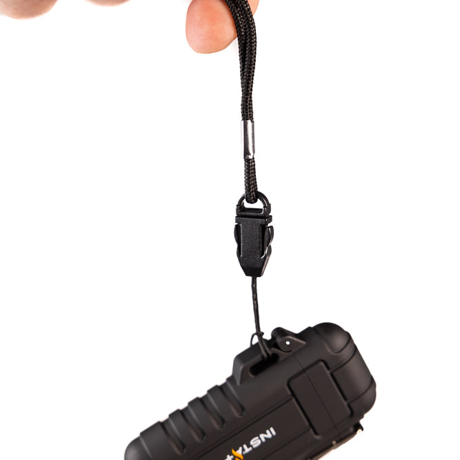 hand holding InstaFire pocket plasma lighter by lanyard