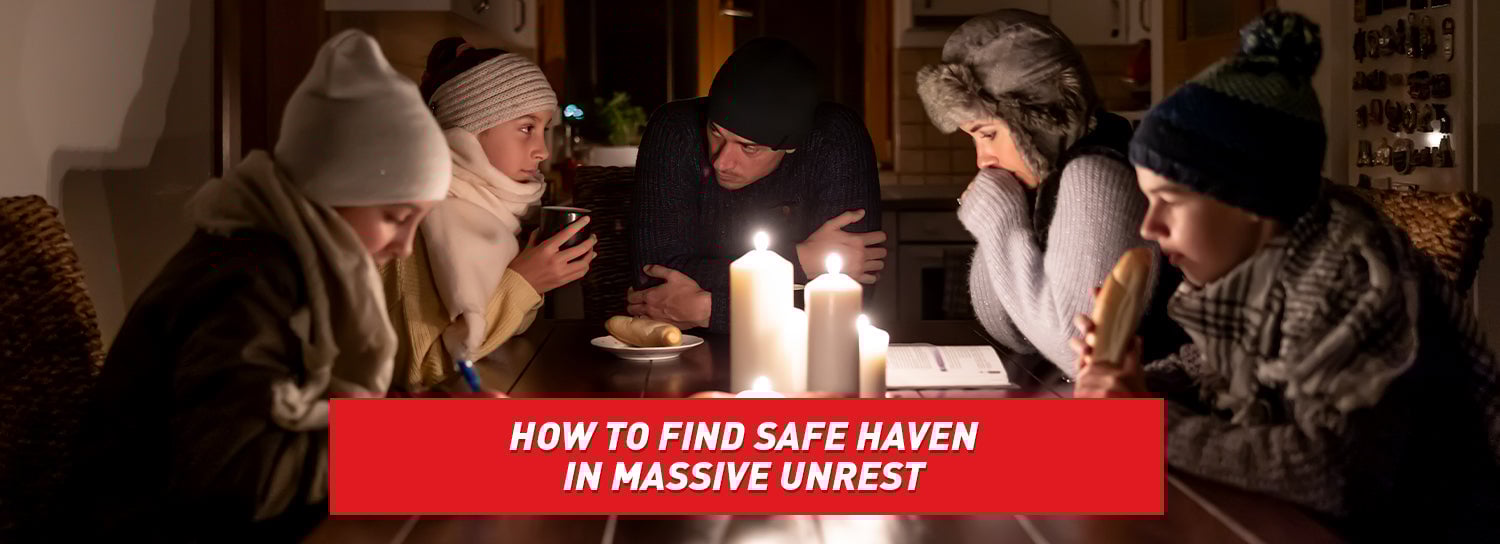 A family in warm clothes huddled together around a table with lit candles in the center.