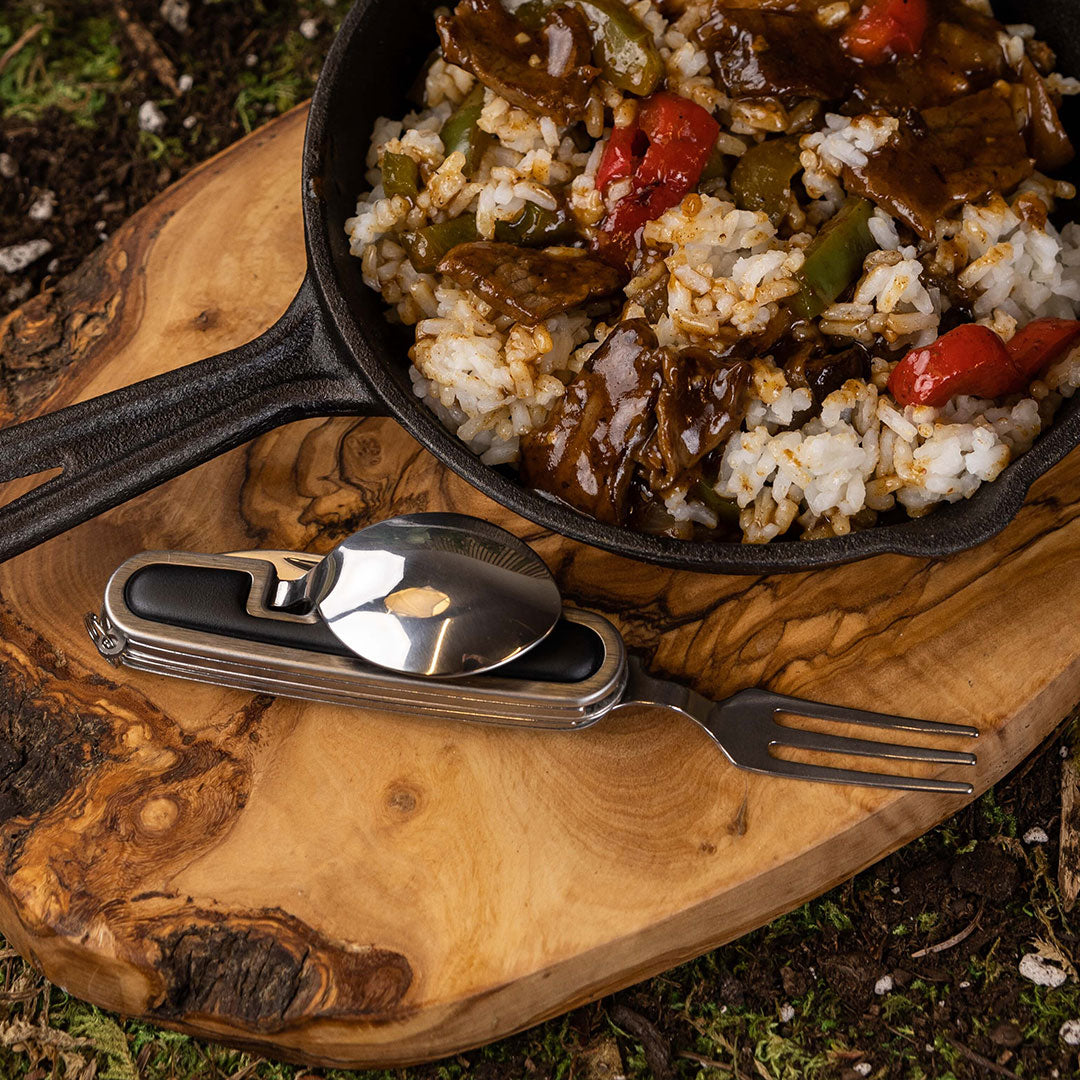 Silverware tool beside skillet