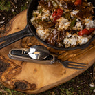 Silverware tool beside skillet