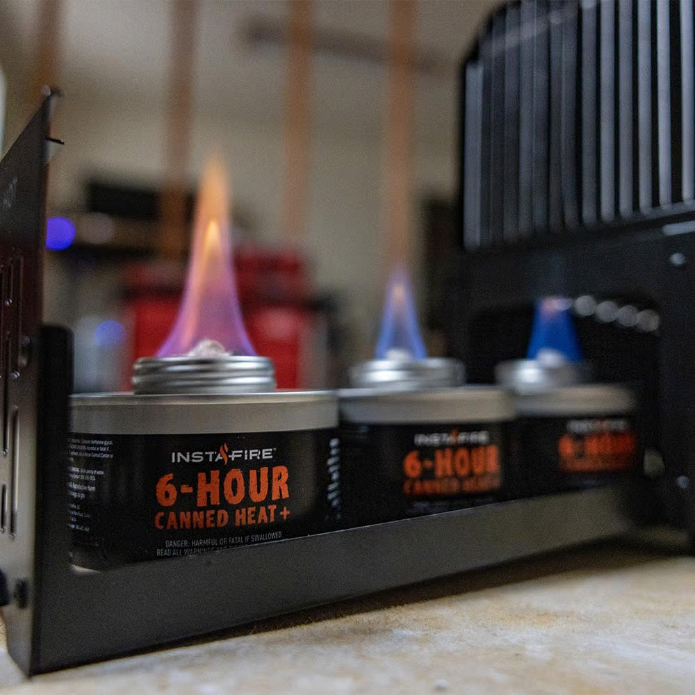 InstaFire 6-Hour Canned Heat cans with flames in a workshop setting