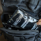water pouch being inserted into go bag