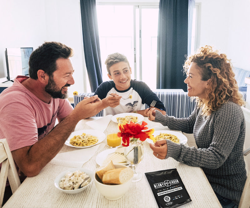 Three people enjoying a meal together at a dinner table