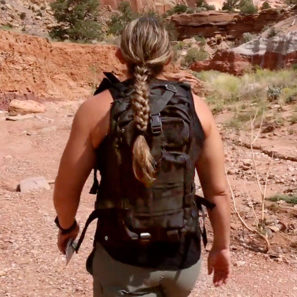 "Survivalist carrying backpack through rugged terrain, prepared for emergency scenarios