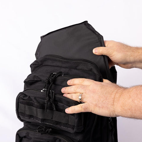 Image of inserting ballistic panel into ready hour tactical backpack 