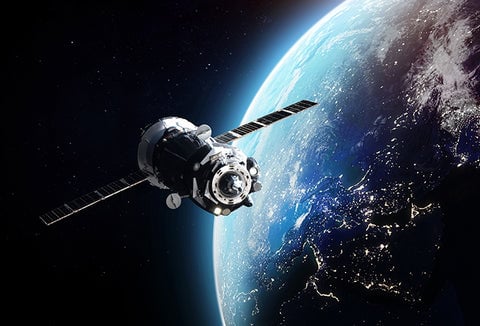 A large satellite flying around Earth in space.