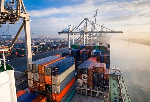 A bunch of shipping containers sitting at a port.