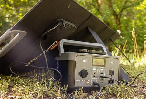 The Grid Doctor 300 generator plugged into solar panels outdoors.