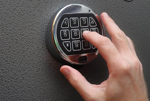 Someone inputting a code on a locked safe.
