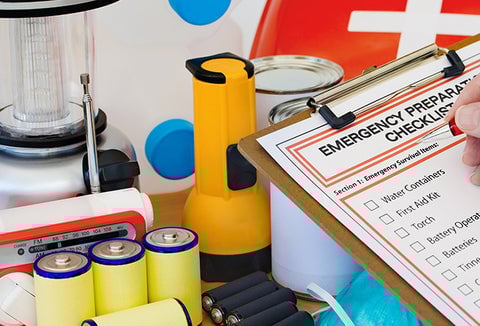 A person checking off a preparedness checklist.