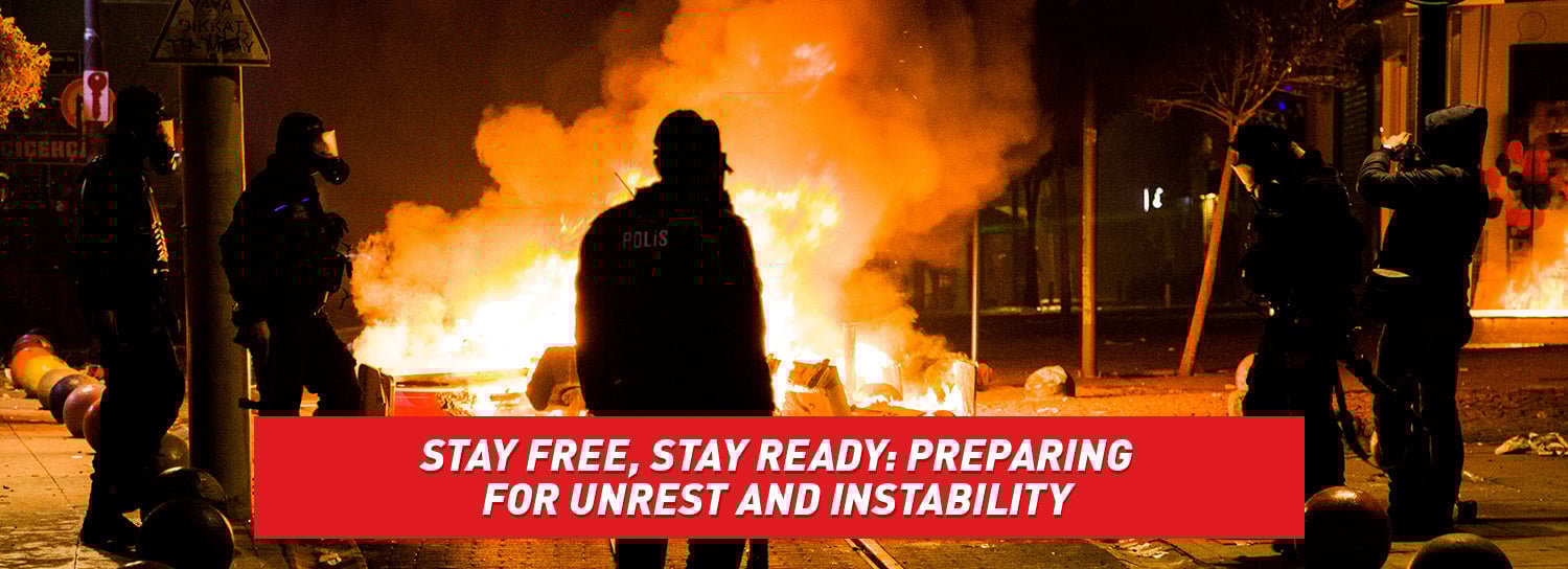 Silhouettes of police officers and citizens while a city burns into flames.