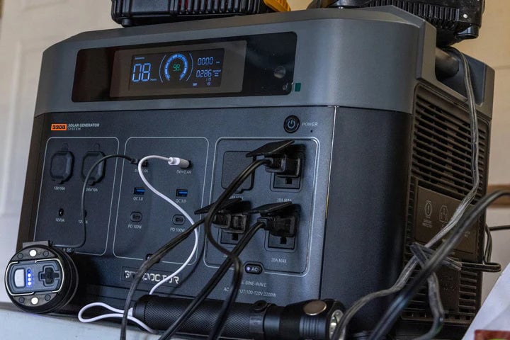 Shows the Grid Doctor system being used to charge power tools.