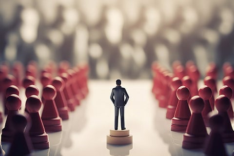 A human character on a chess pawn, surrounded by red chess pawns.