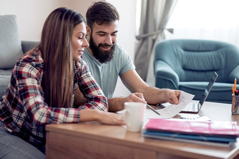 A man and woman going over an emergency plan in their home.