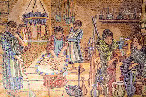 An old mosaic depicting a community cooking and working together.