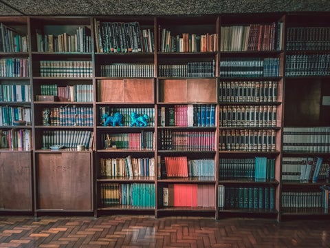 A wall full of bookshelves packed with books.