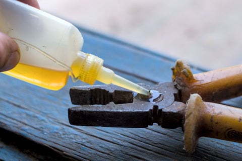 Cooking oil in a small bottle lubricating worn pliers.